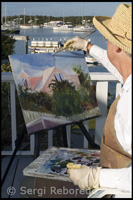Pintora pintant el port de Hope Town - Elbow Cay - Abaco. Bahames