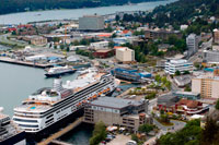 Juneau, Alaska, USA. Juneau downtown, city. Alaska. USA. Cruises ship dockeds between snow capped mountains and the Mount Roberts Tramway in Juneau dock, Alaska, USA. Cruise Ship Terminal and Mt Roberts Tramway, Alaska, Inside Passage, United States of America. The City and Borough of Juneau is the capital city of Alaska. It is a unified municipality located on the Gastineau Channel in the Alaskan panhandle, and is the second largest city in the United States by area. Juneau has been the capital of Alaska since 1906, when the government of what was then the District of Alaska was moved from Sitka as dictated by the U.S. Congress in 1900. 