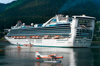 Juneau, Alaska, USA. Star Princess docked at the South Franklin dock, Juneau, Alaska. Sightseeing seaplanes parked at the water front in Juneau dock Alaska. Downtown Juneau sits snugly between Mount Juneau, Mount Roberts and Gastineau Channel, and is a maze of narrow streets running past a mix of new structures, old storefronts and quaint houses featuring early 19th century architecture