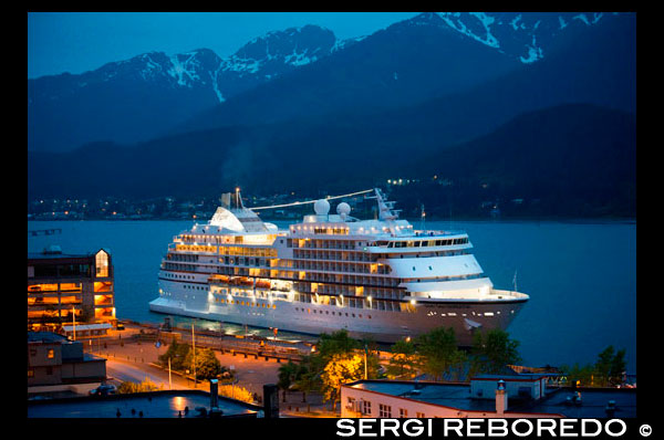 View of the pier and downtown of Juneau, Alaska. Downtown Juneau sits snugly between Mount Juneau, Mount Roberts and Gastineau Channel, and is a maze of narrow streets running past a mix of new structures, old storefronts and quaint houses featuring early 19th century architecture left over from the town’s early gold mining days. The waterfront bustles with cruise ships, fishing boats and floatplanes zipping in and out. With no road access to Juneau, it is the only state capital in the United States that can only be reached by airplane or boat. 