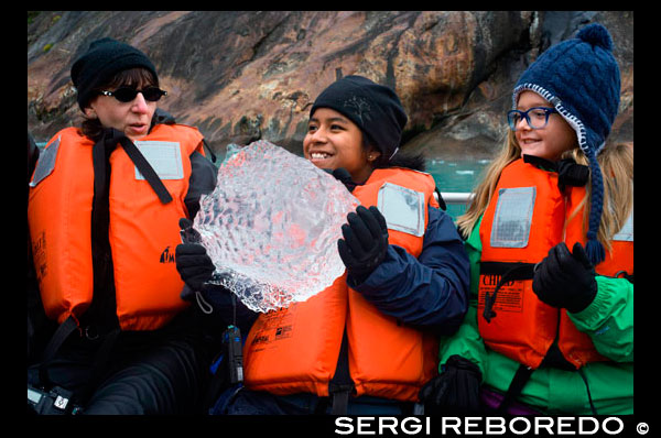 Passengers of Safari Endeavour cruise playing with a big ice at Fords Terror, Endicott Arm, Tongass National Forest, Alaska, USA. The 49th State, the largest in the U.S., is perfect for cruisers, with numerous opportunities to appreciate its vast natural beauty. Sail along the Inside Passage to visit the immense ice formations of Glacier Bay and Icy Strait, as well popular ports such as Ketchikan, Skagway and Juneau, the only U.S. state capital that's not accessible by car. Or travel further north to the Kenai Peninsula and nearby Anchorage, a perfect jumping off point for cruisetours to Denali, Fairbanks and Canada's Yukon. Maybe you'll see a bear!