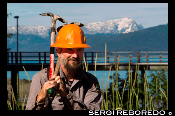 Worker in Bartlett Cove. Pier and floating dock, Bartlett Cove, Glacier Bay National Park, Alaska. Here, just 200 years ago stood the snout of a 100-mile long glacier. Though icebergs no longer dot the waters of Bartlett Cove, the animals, plants, and landscape continue to change after being affected by the Neoglacial Ice Age. There are many ways to explore Bartlett Cove. You may wish to investigate the area on your own, with a small group, or as part of a Ranger Naturalist guided hike or talk. Whatever the method, the beauty of Bartlett Cove and the events that took place here are well worth discovering. Bartlett Cove is the only developed area in Glacier Bay National Park. Join Ranger Tim and explore the activities, trails, lodging, and other highlights found at this remote wilderness outpost.