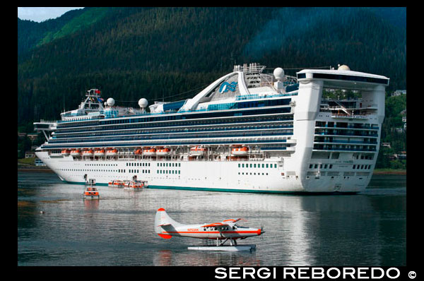 Star Princess docked at the South Franklin dock, Juneau, Alaska. Sightseeing seaplanes parked at the water front in Juneau dock Alaska. Downtown Juneau sits snugly between Mount Juneau, Mount Roberts and Gastineau Channel, and is a maze of narrow streets running past a mix of new structures, old storefronts and quaint houses featuring early 19th century architecture left over from the town’s early gold mining days. The waterfront bustles with cruise ships, fishing boats and floatplanes zipping in and out. With no road access to Juneau, it is the only state capital in the United States that can only be reached by airplane or boat. 