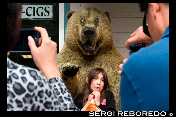 Shops in Downtown. Fear. Asian tourists photographing her daughter next to a stuffed bear. S Franklin street. Alaska Shirt Company. Alaska, USA.  The City and Borough of Juneau is the capital city of Alaska. It is a unified municipality located on the Gastineau Channel in the Alaskan panhandle, and is the second largest city in the United States by area. Juneau has been the capital of Alaska since 1906, when the government of what was then the District of Alaska was moved from Sitka as dictated by the U.S. Congress in 1900. The municipality unified on July 1, 1970, when the city of Juneau merged with the city of Douglas and the surrounding Greater Juneau Borough to form the current home rule municipality. The area of Juneau is larger than that of Rhode Island and Delaware individually and is almost as large as the two states combined. Downtown Juneau  is nestled at the base of Mount Juneau and across the channel from Douglas Island. As of the 2010 census, the City and Borough had a population of 31,275. In July 2013, the population estimate from the United States Census Bureau was 32,660, making it the second most populous city in Alaska after Anchorage.(Fairbanks is however the second-largest metropolitan area in the state, with more than 97,000 residents.) Between the months of May and September, Juneau's daily population can increase by roughly 6,000 people from visiting cruise ships.