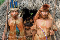 Yagua town. Group leaders pose with the central hut used to perform different acts and shows.