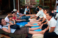 Bangkok. Chinese people Foot massage in Khao San Road. Bangkok. Thailand. Hippy, hippies, backpacker's mecca of Khaosan, Khao San Road, massage, street, relaxing, foot, Banglamphu, area, Bangkok, Thailand, Asia,. You'll find the foot massage business in various places. If the choice is yours, why don't you choose 'Reflexology' at our clean, air-conditioned place with special chairs for foot massage!!  This treatment starts with herbal foot soak. After the actual foot massage, we offer a relaxing, short Thai massage from head, shoulder, back and neck. 