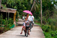 Bangkok. Asian tourists round the island by bicycle. Ko Kret (also Koh Kred) is an island in the Chao Phraya River, 20 km north of Bangkok, Thailand. The island dates only to 1722, when a canal was constructed as a shortcut to bypass a bend in the Om Kret branch of the Chao Phraya river. As the canal was widened several times, the section cut off eventually became a separate island. The island continues to serve as a refuge to the Mon tribes who dominated central Thailand between the 6th and 10th centuries and have retained a distinct identity in their version of Buddhism and, particularly at Ko. One way to reach Ko Kret is to take the once-weekly Chao Phraya Express, which leaves the Central Pier (BTS Saphan Taksin) every Sunday at 09:00 and visits a number of attractions before returning at 15:30.