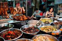 Bangkok. Market stall and street food being prepared in Chinatown Bangkok, Thailand. Yaowarat, Bangkok’s Chinatown, is the World’s most renowned street food destination and the local favorite dining district. On this early night adventure, we bring to you discover the sophisticated flavors of Bangkok’s 200 years old community that is rich with Thai-Chinese tradition & delicious food. During the tour you will walk to explore & taste local cuisines from 7 famous eateries, varied from street food vendors to renowned Thai-Chinese diners. Between each tasting location, you will get behind-the-scene exposure of this unique neighborhood: meeting the food bazaar’s lively characters, hearing its memorable stories