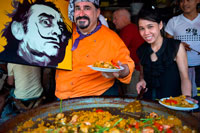 Bangkok. Viva 8 chef Fernando Andrés Yusta posing near sea food paella pan, Chatuchak Weekend Market. Chatuchak Weekend Market or Jatujak Market; is one of the world's largest weekend markets covers area of 70 rai (27 Acres) altogether divided into 27 Sections, contains more than 15,000 booths selling goods from every part of Thailand. Chatuchak Weekend Market,is very popular shopping centre to Thais and has become a popular place to tourists and foreigners who stay in Bangkok, has over 200,000 visitors each day(SAT-SUN) 30% is foreign.