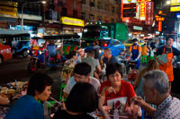 Bangkok. Restaurants and nightlife in Thanon Yaowarat road at night in central Chinatown district of Bangkok Thailand. Yaowarat and Phahurat is Bangkok's multicultural district, located west of Silom and southeast of Rattanakosin. Yaowarat Road is the home of Bangkok's sizable Chinese community, while those of Indian ethnicity have congregated around Phahurat Road. By day, Yaowarat doesn't look that much different from any other part of Bangkok, though the neighbourhood feels like a big street market and there are some hidden gems waiting to be explored. But at night, the neon signs blazing with Chinese characters are turned on and crowds from the restaurants spill out onto the streets, turning the area into a miniature Hong Kong (minus the skyscrapers).