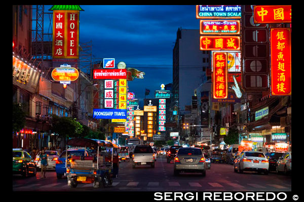 Vegi avall de la carretera Thanon Yaowarat a la nit al cèntric barri de Chinatown de Bangkok, Tailàndia. Yaowarat i Phahurat és multicultural barri de Bangkok, situada a l'oest de Silom i sud-est de Rattanakosin. Yaowarat Road és la llar de la comunitat xinesa gran de Bangkok, mentre que els d'ètnia índia s'han congregat al voltant Phahurat Road. Durant el dia, Yaowarat no es veu molt diferent de qualsevol altra part de Bangkok, encara que el barri se sent com un gran mercat del carrer i hi ha algunes joies ocultes esperant a ser explorat. Però a la nit, els rètols de neó resplendents amb caràcters xinesos estan encesos i les multituds dels restaurants es deixen caure pels carrers, convertint la zona en una miniatura de Hong Kong (menys els gratacels). Phahurat és un lloc excel·lent per a la compra de teles, accessoris i objectes religiosos. Una visita a la zona no està completa sense comptar amb alguns dels seus menjars sorprenents que es venen per una absoluta ganga - com niu d'ocell o alguns curris indis. El barri xinès de Bangkok és una atracció turística popular i un refugi d'aliments per gourmands de nova generació que es reuneixen aquí després del capvespre per explorar la vibrant cuina a peu de carrer. A l'hora del dia, no és menys concorregut, com hordes de compradors descendeixen sobre aquesta franja d'1 km i adjacent Charoenkrung camí per obtenir valor d'un dia de primera necessitat, l'or del comerç, o pagar una visita a un dels temples xinesos. Ple de llocs de mercat, restaurants de carrer i una densa concentració de botigues d'or, el barri xinès és una experiència que no et perdis. L'energia que emana de les seves interminables files de fusta cases-botiga és pla contagiosa - que el mantindrà amb ganes de tornar per més. Organitzeu la vostra visita durant els grans festivals, com l'Any Nou Xinès, i veurà Bangkok Chinatown en el seu millor moment.