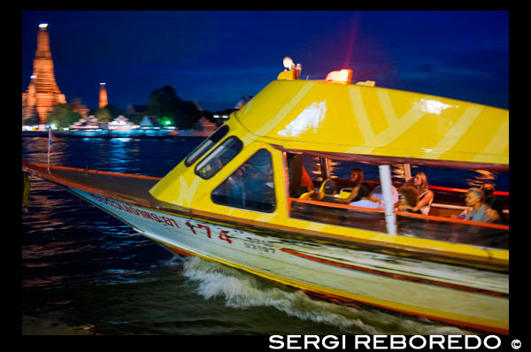 Chao Praya Express Boat at night. Bangkok, Public boat, ferry. Bangkok. Asia.  The Chao Phraya river makes a great way to get around, since many of the major tourist sites are easily accessible from the river. Chao Praya River Express operates a regular boat service up and down the river. Sort of a bus on the water. Fares are extremely cheap - you can get just about anywhere for 11 Baht to 25 Baht (0.34 USD to 0.76 USD) depending on the distance and the type of boat. There are piers next to many of the riverside hotels. Even if you aren't staying on the river, if you are staying close to the elevated train system, you can catch a train to the Taksin Bridge station. A River Express pier is on the river right below the station, and there is generally someone on duty at the pier to sell you a ticket and help plan your trip. The boats can be dangerously crowded during peak traffic times, so avoid rush hours.. Chao Phraya Pier Guide. Bangkok Waterways. Interesting piers found along the 21km Chao Phraya River Express Boat route. Temples, a wet market or an unexpected enclave... if it's something worth seeing then it's here. Once you've decided which piers you want to visit, use the quick links below to familiarise yourself with the different ferry lines, namely their routes, schedules and fares. Then set off on your custom-made - and dirt cheap - adventure on the River of Kings. A quick tip: of the five lines that ply the water the Orange Flag is your best bet - it operates all day. After the morning rush-hour, boats come every 20 minutes until around 16:00 when other lines kick into action and boats appear more frequently. If completely confused by the melee, another more comfortable option is a 'Tourist Boat', though these only come every 30 minutes. Operating Hours: 06:00 - 19:30 Price: Typically between 10 to 15 baht, though long journeys at peak hours can reach 30 baht (fares paid onboard).