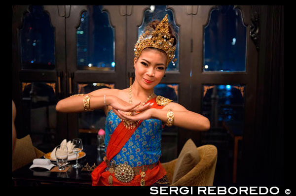 Thai classical dance performance at Salathip Restaurant, Hotel, Shangri La, Bangkok,Thailand, Asia. Salathip is located off New Road on Soi Wat Suan Phlu and is within the Shangri-La Hotel, Bangkok. Serving traditional and classic dishes by the flowing waters of the Chao Phraya River, the "river of kings".  The traditional Thai performances hosted at the restaurant (7-10 pm throughout the week) will certainly keep you glued to the centre stage. And if you are lucky, they may even enact a story which is closely linked to Hindu culture! Don’t be surprised if they enact the Ramayana in front of your very eyes! Guests can relax indoors, or opt for al fresco dining by the river, which can get refreshing owing to a gentle, breezy atmosphere during the evening. The only drawback is the numerous mosquitoes, but who can blame them for wanting to enjoy the picturesque setting too?  Though there are mosquito coils placed under the table, the restaurant, in any case, amply makes up for any such nuisances.Imagine a traditional Thai meal in a posh environment alongside a romantic river. Beautiful, isn’t it? Creating a scene straight from a quixotic movie, Salathip has a perfect setting with live dance performances, so its appeals and impresses on all levels. 