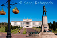 Statue Of Edward Carson In Front Of The Parliament Buildings, Belfast, Northern Ireland. The Parliament Buildings, known as Stormont because of its location in the Stormont area of Belfast is the seat of the Northern Ireland Assembly and the Northern Ireland Executive. It previously housed the old Parliament of Northern Ireland. The building was used for the Parliament of Northern Ireland until it was prorogued in 1972. The Senate chamber was used by the Royal Air Force as an operations room during World War II. The building was used for the short-lived Sunningdale power-sharing executive in 1974. Between 1973 and 1998 it served as the headquarters of the Northern Ireland civil service. Between 1982 and 1986 it served as the seat of the rolling-devolution assembly. It is now the home of the Northern Ireland Assembly. In the 1990s, Sinn Féin suggested that a new parliament building for Northern Ireland should be erected, saying that the building at Stormont was too controversial and too associated with unionist rule to be used by a power-sharing assembly. However, no-one else supported the demand and the new assembly and executive was installed there as its permanent home. On 3 December 2005, the Great Hall was used for the funeral service of former Northern Ireland and Manchester United footballer George Best. The building was selected for the funeral as it is in the only grounds in Belfast suitable to accommodate the large number of members of the public who wished to attend the funeral. Approximately 25,000 people gathered in the grounds, with thousands more lining the cortege route. It was the first time since World War II that the building has been used for a non-governmental or non-political purpose. In springtime in 2006 however the building was reopened for political talks between the MLA's from the various political parties in Northern Ireland. 