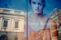 Reflections in a window of one of the shops in the center of Belfast. Belfast's city centre provides a healthy mix of high street names and one-off outlets. The main shopping areas are Donegall Place and Royal Avenue facing the City Hall, Cornmarket off Royal Avenue and, heading south, the Lisburn Road.  Donegall Place, Royal Avenue and Cornmarket are the main streets for familiar names including Marks & Spencer, Boots, Next and WH Smith. Cornmarket and its radial streets have a selection of well-known brands (River Island, French Connection, Habitat:) and low-budget options, especially along Ann Street.  Belfast city centre's biggest shopping mall is CastleCourt on Royal Avenue. If you want to explore smaller city centre outlets and craft shops, check out Donegall Arcade, Spires Mall, the Foutain Centre and the Dublin Road. Queen's Arcade houses several fine jewellery shops.  Botanic Avenue and the Cathedral Quarter are worth browsing for student-style clothes and accessories.  Lisburn Road, also known as Belfast's Bond Street or the Diamond Mile, is where the city's jet set swipe their plastic. It has a great range of designer boutiques, interiors showrooms, art galleries and speciality shops.  