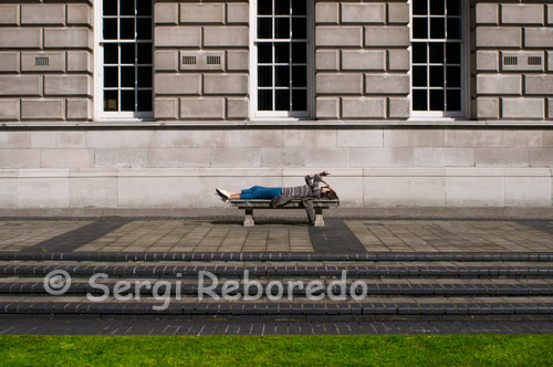 A woman lies on Donegall Square. Donegall Square is a square in the centre of Belfast, County Antrim, Northern Ireland. In the centre is Belfast City Hall, the headquarters of Belfast City Council. Each side of the square is named according to its geographical location, i.e. Donegall Square North, South, East and West. It is named after the Donegall family. Other streets to bear their name in Belfast are Donegall Road, Donegall Pass and Donegall Street. Donegall Place, the city's main shopping street, runs from the north side of the square. There’s a stop off at Bobby Sands’ mural on the side of Sinn Fein offices and the republican gift shop to hear about the hunger strike, and then down to the nearby International Wall that pictorially relates to “other civil wars” across the world. It’s obvious that across Belfast the murals are constantly being touched up and updated. Fascinating to see how every panel on the wall has been adapted to call for Marion Price’s freedom. The final stop on the political tour is the Crown Bar