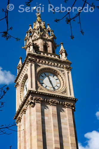 The Albert Memorial Clock is a tall clock tower situated at Queen's Square in Belfast, Northern Ireland. It was completed in 1869 and is one of the best known landmarks of Belfast. In 1865 a competition for the design of a memorial to Queen Victoria's late Prince Consort, Prince Albert, was won by W. J. Barre, who had earlier designed Belfast's Ulster Hall. Initially Barre was not awarded his prize and the contract was secretly given to Lanyon, Lynn, and Lanyon, who had come second. Following public outcry the contract was eventually awarded to Barre. The construction cost of £2,500 (2011: £181,000) was raised by public subscription. The sandstone memorial was constructed between 1865 and 1869 by Fitzpatrick Brothers builders and stands 113 feet tall in a mix of French and Italian Gothic styles. The base of the tower features flying buttresses with heraldic lions. A statue of the Prince in the robes of a Knight of the Garter stands on the western side of the tower and was sculpted by SF Lynn. A two tonne bell is housed in the tower and the clock was made by Francis Moore of High Street, Belfast. As a result of being built on wooden piles on marshy, reclaimed land around the River Farset, the top of the tower leans four feet off the perpendicular. Due to this movement, some ornamental work on the belfry was removed in 1924 along with a stone canopy over the statue of the Prince. Being situated close to the docks, the tower was once infamous for being frequented by prostitutes plying their trade with visiting sailors. However, in recent years regeneration has turned the surrounding Queen's Square and Custom's House Square into attractive, modern public spaces with trees, fountains and sculptures. In 1947, the film Odd Man Out was filmed partly in Belfast, with the Albert Clock as a central location, although neither the town nor the clock is explicitly identified. The clock was damaged in a Provisional Irish Republican Army bomb explosion outside nearby River House in High Street on 6 January 1992. 