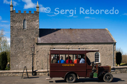 Ulster folk & transport museum. Ballycultra town Buildings. Church of Ireland At the time Kilmore Church was built in 1790, the Church of Ireland was still the Established Church in Ireland, and was supported by tithes.  This 10 per cent payment of the annual produce of land or labour was made to the church by the entire population, whether they belonged to it or not. This small Anglican (Protestant Episcopalian) church was built to accommodate 160 people, although parish records show the usual attendance was about 100 worshippers. An argument raged throughout the Anglican Communion in the 1840s and 1850s over the nature of worship and the use of rituals introduced by the Anglo-Catholic movement.  To heal this rift in the parish, the new rector who was appointed in 1868, built a new church nearby and this building served as a parish hall, a school and a store. In the 1880s it became common for Anglican churches to replace their box pews with rows of open pews. When Kilmore Church was being moved to the Museum, the layout of the original box pews was clearly visible on the floor and it was decided to reinstate the original 18th century interior. Original location: Kilmore, Crossgar, County Down 