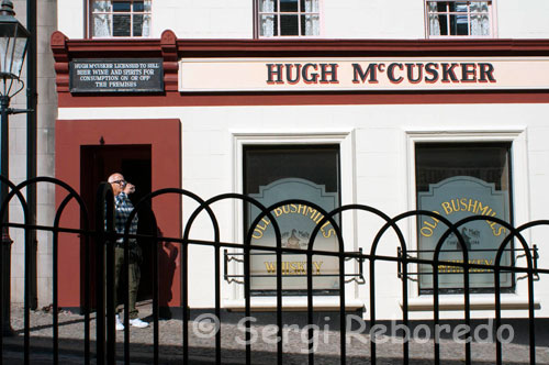 Ulster folk & transport museum. Ballycultra town Buildings. McCusker's Pub. Believe it or not, it is only in recent years that that the consumption of alcohol has become socially acceptable.  In the 19th century, there was a degree of shame associated with being seen entering or leaving a public house, such as McCusker’s Pub. Yet ironically, the public house was a centre of social life in many Irish towns. In spite of various temperance movements of the 19th century, the great religious revival of 1859 amongProtestant denominations, the Catholic religious revival of the 1880s and 1890s and the founding of the Pioneer Total Abstinence Association in 1901, many public houses continued to trade and to make a living. For many folk, the pub offered a welcome, if temporary, escape from the grind of daily life.  It meant relief from long hours working in arduous and often dangerous conditions, or the terrible overcrowding in some inner-city areas and the generally miserable living conditions of working people.  Spirits, especially gin and whiskey, were consumed in large quantities. Periodically great concern was expressed at the high level of consump tion by the working classes. Of course, the middle and uppe r classes were by no means teetotal - they could drink in comfort in their clubs or at home, although the quantities they consu med tended to be much smaller.  Replica, location of original: Upper Irish Street, Armagh, County Armagh. 