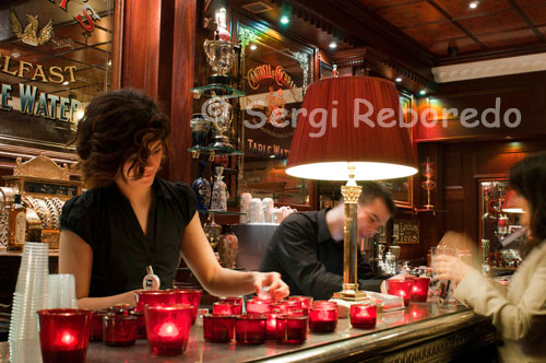 A waitress inside the Dark Horse. Take a stroll along the atmospheric cobble stoned streets of the Cathedral Quarter, around to Commercial Court, and you’ll come across a piece of Belfast history. Bringing back the long lost tradition of the coffee house to the city, walking into the Dark Horse is like stepping back in time. Traditional Coffee House The little sister of the Duke of York, the historic pub that stands opposite in Commercial Court, the coffee house was the brainchild of the pub’s owner Willie Jack, who wanted to combine the atmosphere of a traditional Irish coffee house, such as Bewley’s, with a more continental flavour. He appointed Mark Hamill, also from the Duke of York, as manager and gave him free rein to develop his ideas. The Dark Horse was opened during a snowstorm in 2010 and after a slow start has become one of the area’s most popular venues. Special Atmosphere One of the key attributes of the coffee house is its old fashioned décor, an area which Willie Jack was able to influence directly. “Willie is also an antique dealer,” Mark says, “and has been able to supply a host of wonderful and constantly changing artefacts that give the place such a special atmosphere. For instance, we have had some lovely old oil lamps converted to ceiling lamps and we have some wallpaper from the same company that supplied Titanic. We also have a series of old Belfast trophies and lots of little things like a water jug from the Belfast Exhibition of 1895. They really bring old Belfast back to life.” 