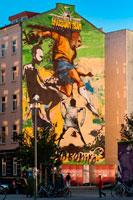 Graffiti in a house near the Mauerpark, Berlin in evening light Germany. Wellcome to Belin, brazilian team. Joga bonito. Mauerpark is a public linear park in Berlin's Prenzlauer Berg district. The name translates to "Wall Park", referring to its status as a former part of the Berlin Wall and its Death Strip. The park is located at the border of Prenzlauer Berg and Gesundbrunnen district of former West Berlin. In the 19th and 20th centuries, the Mauerpark area served as the location of the Old Nordbahnhof ("Northern Railway Station"), the southern terminus of the Prussian Northern Railway opened in 1877-78, which connected Berlin with the city of Stralsund and the Baltic Sea. 