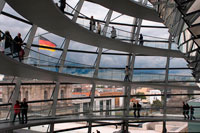 Berlin. Germany. Mirrored cone inside the Reichstag Dome, in the german parlament (Reichstag), Berlin. The current Reichstag dome is an iconic glass dome constructed on top of the rebuilt Reichstag building in Berlin. It was designed by architect Norman Foster and built to symbolize the reunification of Germany. The distinctive appearance of the dome has made it a prominent landmark in Berlin. The Reichstag dome is a large glass dome with a 360 degree view of the surrounding Berlin cityscape.