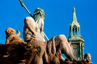 Berlin. Germany. Neptunbrunnen Fountain, Marienkirche Church in the back, Alexanderplatz Square, Berlin-Mitte, Germany, Europe.  The Neptune Fountain in Berlin was built in 1891 and was designed by Reinhold Begas. The Roman god Neptune is in the center. The four women around him represent the four main rivers of Prussia: Elbe, Rhine, Vistula, and Oder.