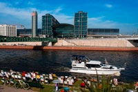 Berlin. Germany. Boat excursion in the Spree river, Berlin. At back Berlin Hauptbahnhof train station. Spree, Landwehrkanal and Havel – Berlin is crossed by a multitude of rivers and canals. Did you know that Berlin, with its 1,700 bridges, has more bridges than Venice? A discovery of the city on water creates unusual outlooks on the capital. When the weather is good, you can relax on the boat decks and marvel at the sights, as well as at unknown corners of the metropolis. From March to October, the shipping companies of Berlin offer various tours of the city as well as its surrounding areas, including competent explanations and stories from the ship crew.