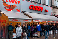 Famous Curry 36 sausage restaurant Kreuzberg west Berlin Germany Europe. If you want to eat currywurst the Berlin way, order yours here boiled and naked ("ohne darm", without skin), looking a little pale in comparison with the ones in pink skins. The sausage at this particular snack bar is so popular that they've started a range of merchandise sporting their daft logo. Besides the currywurst there's bockwurst, krakauers and several other types of sausage as well as proletarian Berlin specialities such as fried burgers and bouletten (meatballs/patties). Take it away or wolf it all down at one of the outdoor stand-up tables.