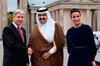 Berlin. Germany. Berlin Major Klaus Wowereit (C), accompanies the Emir of Qatar, Hamad bin Khalifa Al Thani (L), and his wife Mozah Binti Nasser Al Missned (R), to the landmark Brandenburg Gate in Berlin, Germany. Qatar celebrates its National Day in commemoration of the historic day in 1878 when Shaikh Jasim succeeded his father, Shaikh Muhammad Bin Thani, as a ruler and led the country towards unity. The event on December 18 is considered as an opportunity for all Qatari nationals and expatriates to recognise and celebrate what it means to live in modem day Qatar.