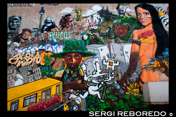 Mural art, graffiti, Kreuzberg, Berlin, Germany, Europe. Berlin “the graffiti Mecca of the urban art world.” While few people would argue with her, the Berlin street scene is not as radical as her statement suggests. Street art in Berlin is a big industry. It’s not exactly legal, but the city’s title of UNESCO’s City of Design has kept local authorities from doing much to change what observers call the most “bombed” city in Europe. From the authorities’ point of view, the graffiti attracts tourists, and the tourists bring money to a city deep in debt. They saw big bubbly letters, spelling out words in German, English and French. They saw political slogans, either carved indelibly into the concrete or sprayed temporarily onto surfaces, commenting not only on the situation in Germany, but on the whole political world: “God Ble$$,” “Concrete Makes You Happy,” “Death to Tyrants.” As far as they could see, covering every inch of wall, was layer upon layer of zest, life and color.
