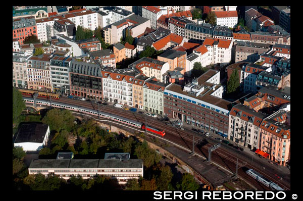 Berlin Panorama from the Fernsehturm with the shadow of the tower, Berlin, Germany. Diferents trains. View across Berlin from the observation deck of the Fernsehturm TV Tower in East Berlin. Buildings and trains. Close to Alexanderplatz in Mitte, the tower was constructed between 1965 and 1969 by the administration of the German Democratic Republic. It was intended as a symbol of Berlin, which it remains today, as it is easily visible throughout the central and some suburban districts of Berlin. With its height of 368 meters, it is the tallest structure in Germany. The tower has become one of the most prominent symbols of the country and is often in the establishing shot of films set in Berlin. Due to its location near Alexanderplatz, the tower is occasionally called Alex Tower, especially by Berlin visitors.