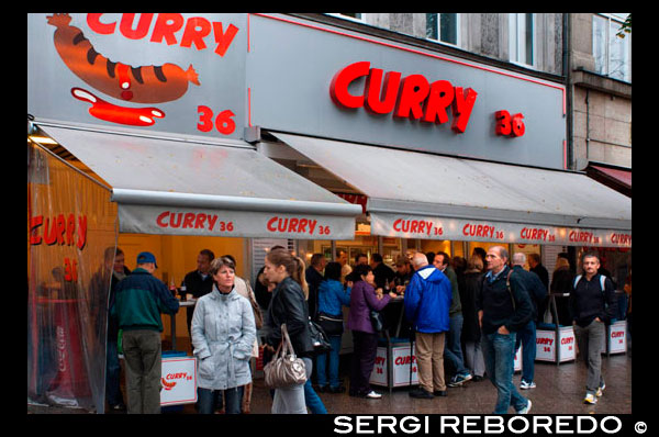 Famous Curry 36 sausage restaurant Kreuzberg west Berlin Germany Europe. If you want to eat currywurst the Berlin way, order yours here boiled and naked ("ohne darm", without skin), looking a little pale in comparison with the ones in pink skins. The sausage at this particular snack bar is so popular that they've started a range of merchandise sporting their daft logo. Besides the currywurst there's bockwurst, krakauers and several other types of sausage as well as proletarian Berlin specialities such as fried burgers and bouletten (meatballs/patties). Take it away or wolf it all down at one of the outdoor stand-up tables. • Mehringdamm 36, Kreuzberg, no telephone, www.curry36.de. Mon-Sun 9am-5pm. Currywurst €2.50