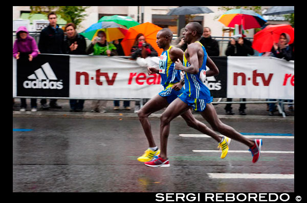 Black African participant of the Berlin Marathon at kilometer 40, Berlin, Germany, Europe. The Berlin Marathon (branded BMW Berlin Marathon for sponsorship reasons) is a major running and sporting event held annually in Berlin, Germany. The official marathon distance of 42.195 kilometers (26 miles 385 yards) is set up as a city-wide road race where professional athletes and amateur runners jointly participate. First initiated in 1974, the event traditionally takes place on the last weekend in September. The Berlin marathon is one of the largest and most popular road races in the world. In 2008 alone the race had 40,827 enrolled starters from 107 countries, 35,913 official finishers and more than one million spectators. Along with five other races, it forms the World Marathon Majors, a series offering a $1 million prize purse to be split equally between the top male and female marathoners. The most marathon world records for men and women have been set at the Berlin course, which is known for its flat profile, even surface, cheering spectators, and its frequently mild autumn temperatures. The event is split over 2 days. About 8,000 additional inline skaters compete at the marathon course the Saturday before the running event. Power walkers, handbikers, wheelchair riders, and a children's marathon (4.2195 km) are also part of the marathon weekend, which is organised by SCC EVENTS and currently sponsored by BMW.