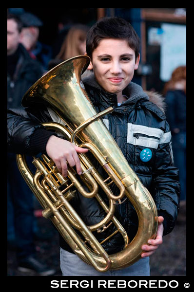 Boy with a tuba. Music, dance, party and costumes in Binche Carnival. Ancient and representative cultural event of Wallonia, Belgium. The carnival of Binche is an event that takes place each year in the Belgian town of Binche during the Sunday, Monday, and Tuesday preceding Ash Wednesday. The carnival is the best known of several that take place in Belgium at the same time and has been proclaimed as a Masterpiece of the Oral and Intangible Heritage of Humanity listed by UNESCO. Its history dates back to approximately the 14th century. Events related to the carnival begin up to seven weeks prior to the primary celebrations. Street performances and public displays traditionally occur on the Sundays approaching Ash Wednesday, consisting of prescribed musical acts, dancing, and marching. Large numbers of Binche's inhabitants spend the Sunday directly prior to Ash Wednesday in costume. The centrepiece of the carnival's proceedings are clown-like performers known as Gilles. Appearing, for the most part, on Shrove Tuesday, the Gilles are characterised by their vibrant dress, wax masks and wooden footwear. They number up to 1,000 at any given time, range in age from 3 to 60 years old, and are customarily male. The honour of being a Gille at the carnival is something that is aspired to by local men