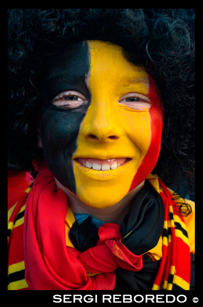Boy painted with a belgium flag. Music, dance, party and costumes in Binche Carnival. Ancient and representative cultural event of Wallonia, Belgium. The carnival of Binche is an event that takes place each year in the Belgian town of Binche during the Sunday, Monday, and Tuesday preceding Ash Wednesday. The carnival is the best known of several that take place in Belgium at the same time and has been proclaimed as a Masterpiece of the Oral and Intangible Heritage of Humanity listed by UNESCO. Its history dates back to approximately the 14th century. Events related to the carnival begin up to seven weeks prior to the primary celebrations. Street performances and public displays traditionally occur on the Sundays approaching Ash Wednesday, consisting of prescribed musical acts, dancing, and marching. Large numbers of Binche's inhabitants spend the Sunday directly prior to Ash Wednesday in costume. The centrepiece of the carnival's proceedings are clown-like performers known as Gilles. Appearing, for the most part, on Shrove Tuesday, the Gilles are characterised by their vibrant dress, wax masks and wooden footwear. They number up to 1,000 at any given time, range in age from 3 to 60 years old, and are customarily male. The honour of being a Gille at the carnival is something that is aspired to by local men
