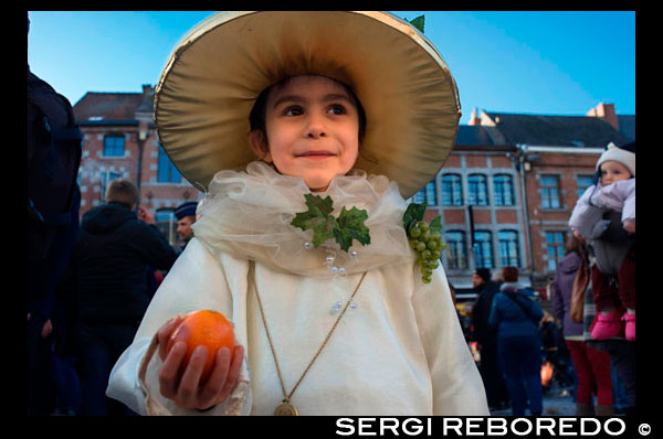 Child dressed with a costume. Music, dance, party and costumes in Binche Carnival. Ancient and representative cultural event of Wallonia, Belgium. The carnival of Binche is an event that takes place each year in the Belgian town of Binche during the Sunday, Monday, and Tuesday preceding Ash Wednesday. The carnival is the best known of several that take place in Belgium at the same time and has been proclaimed as a Masterpiece of the Oral and Intangible Heritage of Humanity listed by UNESCO. Its history dates back to approximately the 14th century. Events related to the carnival begin up to seven weeks prior to the primary celebrations. Street performances and public displays traditionally occur on the Sundays approaching Ash Wednesday, consisting of prescribed musical acts, dancing, and marching. Large numbers of Binche's inhabitants spend the Sunday directly prior to Ash Wednesday in costume. The centrepiece of the carnival's proceedings are clown-like performers known as Gilles. Appearing, for the most part, on Shrove Tuesday, the Gilles are characterised by their vibrant dress, wax masks and wooden footwear. They number up to 1,000 at any given time, range in age from 3 to 60 years old, and are customarily male. The honour of being a Gille at the carnival is something that is aspired to by local men