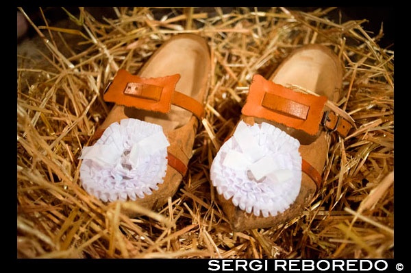 Clogs for dressing at home for the Binche Carnival. Preparation, preparations, put the dress. The carnival of Binche is an event that takes place each year in the Belgian town of Binche during the Sunday, Monday, and Tuesday preceding Ash Wednesday. The carnival is the best known of several that take place in Belgium at the same time and has been proclaimed as a Masterpiece of the Oral and Intangible Heritage of Humanity listed by UNESCO. Its history dates back to approximately the 14th century. Events related to the carnival begin up to seven weeks prior to the primary celebrations. Street performances and public displays traditionally occur on the Sundays approaching Ash Wednesday, consisting of prescribed musical acts, dancing, and marching. Large numbers of Binche's inhabitants spend the Sunday directly prior to Ash Wednesday in costume. The centrepiece of the carnival's proceedings are clown-like performers known as Gilles. Appearing, for the most part, on Shrove Tuesday, the Gilles are characterised by their vibrant dress, wax masks and wooden footwear. They number up to 1,000 at any given time, range in age from 3 to 60 years old, and are customarily male. The honour of being a Gille at the carnival is something that is aspired to by local men