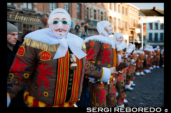 Belgium, carnaval of Binche. UNESCO World Heritage Parade Festival. Belgium, Walloon Municipality, province of Hainaut, village of Binche.  The carnival of Binche is an event that takes place each year in the Belgian town of Binche during the Sunday, Monday, and Tuesday preceding Ash Wednesday. The carnival is the best known of several that take place in Belgium at the same time and has been proclaimed as a Masterpiece of the Oral and Intangible Heritage of Humanity listed by UNESCO. Its history dates back to approximately the 14th century. Events related to the carnival begin up to seven weeks prior to the primary celebrations. Street performances and public displays traditionally occur on the Sundays approaching Ash Wednesday, consisting of prescribed musical acts, dancing, and marching. Large numbers of Binche's inhabitants spend the Sunday directly prior to Ash Wednesday in costume. The centrepiece of the carnival's proceedings are clown-like performers known as Gilles. Appearing, for the most part, on Shrove Tuesday, the Gilles are characterised by their vibrant dress, wax masks and wooden footwear. They number up to 1,000 at any given time, range in age from 3 to 60 years old, and are customarily male. The honour of being a Gille at the carnival is something that is aspired to by local men