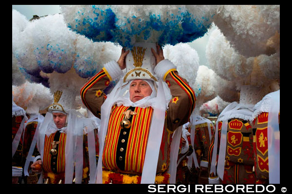 Belgium, carnaval of Binche. UNESCO World Heritage Parade Festival. Belgium, Walloon Municipality, province of Hainaut, village of Binche. The carnival of Binche is an event that takes place each year in the Belgian town of Binche during the Sunday, Monday, and Tuesday preceding Ash Wednesday. The carnival is the best known of several that take place in Belgium at the same time and has been proclaimed as a Masterpiece of the Oral and Intangible Heritage of Humanity listed by UNESCO. Its history dates back to approximately the 14th century. Events related to the carnival begin up to seven weeks prior to the primary celebrations. Street performances and public displays traditionally occur on the Sundays approaching Ash Wednesday, consisting of prescribed musical acts, dancing, and marching. Large numbers of Binche's inhabitants spend the Sunday directly prior to Ash Wednesday in costume. The centrepiece of the carnival's proceedings are clown-like performers known as Gilles. Appearing, for the most part, on Shrove Tuesday, the Gilles are characterised by their vibrant dress, wax masks and wooden footwear. They number up to 1,000 at any given time, range in age from 3 to 60 years old, and are customarily male. The honour of being a Gille at the carnival is something that is aspired to by local men