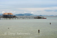 Some local children swim in the beachfront of Pulau Mabul, next to a resort which hosted some of the Subrina each year flock to this place.