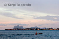 A fisherman out to sea in a tiny boat from the port of Semporna.