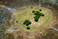 Aerial views from Camp Savute Elephant Camp by Orient Express in Botswna , in the Chobe National Park and Camp Eagle Island Camp by Orient Express Camp , outside the Moremi Game Reserve in Botswana . The Okavango River is a long African river , which rises in the plateau of Bie , Angola , in a fairly rainy , and after a journey of almost 1,000 km enters a drainage basin , and in Botswana , where he has been an extensive alluvial region improperly named and known throughout the world as the Okavango delta . As leads to an area with a very arid climate , it is an allochthonous river , such as the Nile River in Egypt , or the Niger River in Mali. Its watershed drains an area of 721 277 km ² . The rainy season in the delta coincides with that of Angola , which takes place between October and April and in flood of the Okavango River , which begins to be felt in December and takes nine months to complete due to the low gradient of the river , about 60 m at 450 km. The rains are more abundant in the north and lower in the south, where the river goes into the Kalahari.