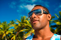 Aitutaki. Cook Island. Polynesia. South Pacific Ocean. A tourist walks along the edge of the palm-fringed beach in One Foot Island.  One of the inhabitants of One Foot Island with his sunglasses on. Aitutaki – the hottest holiday destination in the Cook Islands For those seeking tropical paradise, the South Pacific island of Aitutaki in the Cook Islands is hard to beat. Beautiful, romantic and secluded, the coral atoll of Aitutaki is famed for a vast triangular lagoon regularly voted the most idyllic in the world. Here's what to do on the island! Things to do in Aitutaki Exquisite warm wáter. Exquisitely clear water in myriad shades of luminous turquoise laps dazzling white sand beaches on a dozen lushly vegetated islets, or motus, scattered around the lagoon perimeter. Absolutely compelling, there is no shortage of ways to enjoy and explore the spectacular gin-clear warm waters, which rarely drop below 25?C. Explore the sea. Simply pad across the sand from your beachside room to swim amongst tropical fish or take a day cruise to uninhabited motus and snorkelling spots that will astound you. Giant clams and turtles, rainbow coloured parrotfish, vivid blue starfish, bright yellow angelfish, darting trevally and whitespotted eagle rays are readily spotted amongst colourful coral formations. 