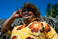 Aitutaki. Cook Island. Polynesia. South Pacific Ocean. Calling by phone with a shell in Aitutaki Punani Culture Tours.  The languages of the Cook Islands include English, Cook Islands M?ori, or "Rarotongan," and Pukapukan. Dialects of Cook Islands Maori include Penrhyn; Rakahanga-Manihiki; the Ngaputoru dialect of Atiu, Mitiaro, and Mauke; the Aitutaki dialect; and the Mangaian dialect. Cook Islands Maori and its dialectic variants are closely related to both Tahitian and to New Zealand M?ori. Pukapukan is considered closely related to the Samoan language. English and Cook Islands Maori are official languages of the Cook Islands. The economy is strongly affected by geography. It is isolated from foreign markets, and has some inadequate infrastructure; it lacks major natural resources, has limited manufacturing and suffers moderately from natural disasters. Tourism provides the economic base which makes up approximately 67.5% of GDP. Additionally, the economy is supported by foreign aid, largely from New Zealand. The Peoples' Republic of China has also contributed foreign aid which has resulted in, among other projects, the Police Headquarters building. The Cook Islands is expanding its agriculture, mining and fishing sectors, with varying success. Since approximately 1989, the Cook Islands have become a location specialising in so-called asset protection trusts, by which debtors, or those fearful of becoming debtors, seek to shelter assets from the reach of creditors. 