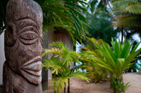 Rarotonga Island. Cook Island. Polynesia. South Pacific Ocean. Totem located outside the luxurious Little Polynesian Resort in Rarotonga. The Little Polynesian is surrounded with the kind of natural beauty that the South Pacific is renowned for. In 2005, the Little Polynesian underwent extensive renovations to unveil what can only be described as a literal re-creation to achieve once again a new level of service and amenities. Our magnificently built Ares (bungalows) have been designed with intricate attention to detail. Every unit uses traditional Cook Islands architecture combined with understated yet richly elegant décor. Little Polynesian a small luxury hideaway in Titikaveka on the island of Rarotonga overlooks a gorgeous white sand swimming beach with excellent snorkeling offshore and there are free kayaks to explore the turquoise lagoon. The no child policy ensures absolute privacy - making it the ideal place for honeymoons and romantic breaks. All rooms are non-smoking. The Little Polynesian offers all the amenities one would expect from the Cook Islands' most upscale boutique resort. The Luxury Beach Ares promise aimless days of looking out to the lagoon's turquoise waters and waking up to the gentle sound of waves, while the scent of tropical flowers fills the air around our garden villas. Traditional accents in the bungalows including Wild Hibiscus, Mangaian (coconut) sinnet weaving on beams as well as a thatched roof with natural Pandanus add to the ambience of our South Seas paradise. The scent of tropical flowers fills the air around the fourGarden Pia Tiare (Garden Villas) - providing a special experience that's close to nature. Like the Beach Ares, each is equipped with a spacious king size bed, out door shower and spa tub and bar fridge. 