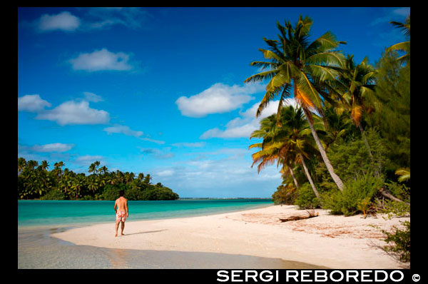 Aitutaki. Cook Island. Polynesia. South Pacific Ocean. A tourist walks along the edge of the palm-fringed beach in One Foot Island.  Stamp Your Passport: Visit Aitutaki’s One Foot Island, where you’ll enjoy the incredible blue lagoon and a mouth watering beach barbecue, as well as a chance to receive Aitutaki’s trademark One Foot passport stamp.. With a vast, sparkling lagoon rivaling Bora Bora’s – but with a fraction of the visitors – Aitutaki just might be the world’s most beautifully-remote island. Just a 45-minute flight from the main island of Rarotonga, Aitutaki and its surrounding atolls served as the tropical backdrop for “Survivor: Cook Islands.” One of 22 islands in the Aitutaki atoll, One Foot Island (or Tapuaetai, “one footprint”) is both dreamily-exotic and nearly deserted. It’s the perfect place to laze on a powder-white beach or float in the knee-high lagoon. While it may look totally deserted, One Foot is home to one top attraction - a small hut containing one of the world’s most remote post offices. Don’t forget to bring your passport and you’ll depart paradise with a footprint-shaped passport stamp to remember it by.  Atiu Island, also known as Enuamanu (‘land of the birds’) lies 187 kilometres north east of Rarotonga. The third-largest island in the Cooks is over eight million years old. It’s also an ecologist’s dream and a magnet for the adventurer. On the edge of the island’s flat-topped central plateau you’ll find Atiu Villas, the island’s most developed vacation spot. You’ll also find 28 untouched beaches that are almost unvisited – except by those seeking a beautiful, secluded spot. Beautiful Aitutaki. It’s believed that the islanders on Aitutaki are descended from Ru, a seafaring warrior who settled there with his four wives. Arriving during a full moon he was captivated by the reflections upon this vast tranquil lagoon and named his landing point O’otu, which means ‘full moon’. Today Aitutaki is renowned for its extraordinary natural beauty and relaxed pace of life. Travellers come in search of the palm-fringed beaches that have been luckily spared from mass tourism.  Romantic Souls. When it comes to sparking the fires of romance, the heady mix of delicious seclusion and outstanding beauty on offer in the Cook Islands can prove to be a pyrotechnic’s dream. Sparks undoubtedly fly for couples seeking adventure on Rarotonga’s safari tours, hikes and paddle board trips, while more relaxed love birds flock to Aitutaki to unwind on its white sand beaches and bask in the sun. Both islands also provide excellent spots to tie the knot or renew your vows, and many resorts provide the services of a coordinator who can help to plan an unforgettable day. Getting hitched in the Cooks is hassle-free, as couples only need to have proper documentation and be in destination for three business days prior to the big day in order to receive a marriage licence.