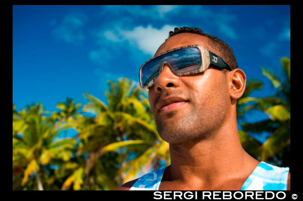 Aitutaki. Cook Island. Polynesia. South Pacific Ocean. A tourist walks along the edge of the palm-fringed beach in One Foot Island.  One of the inhabitants of One Foot Island with his sunglasses on. Aitutaki – the hottest holiday destination in the Cook Islands For those seeking tropical paradise, the South Pacific island of Aitutaki in the Cook Islands is hard to beat. Beautiful, romantic and secluded, the coral atoll of Aitutaki is famed for a vast triangular lagoon regularly voted the most idyllic in the world. Here's what to do on the island! Things to do in Aitutaki Exquisite warm wáter. Exquisitely clear water in myriad shades of luminous turquoise laps dazzling white sand beaches on a dozen lushly vegetated islets, or motus, scattered around the lagoon perimeter. Absolutely compelling, there is no shortage of ways to enjoy and explore the spectacular gin-clear warm waters, which rarely drop below 25?C. Explore the sea. Simply pad across the sand from your beachside room to swim amongst tropical fish or take a day cruise to uninhabited motus and snorkelling spots that will astound you. Giant clams and turtles, rainbow coloured parrotfish, vivid blue starfish, bright yellow angelfish, darting trevally and whitespotted eagle rays are readily spotted amongst colourful coral formations. World's smallest post office. Several cruises stop at One Foot Island, where you can get your passport stamped at the world’s smallest official post office. Other popular landings are the islands where Survivor Cook Islands and the Shipwrecked tv series’ were filmed and a gorgeous swathe of sand aptly named Honeymoon Island. Kite surfing and fishing. Sporty types are drawn to Aitutaki for fantastic kite surfing and to flyfish for the fighting bonefish. Outstanding and quickly accessible scuba diving and deep sea fishing for tuna, marlin and swordfish lies just beyond the reef. Simply relax. Others come simply to relax in tranquil beachside havens ranging from the ultra luxurious, like our Healthy Life Awards 2012 major prize sponsor Pacific Resort Aitutaki, to simple beach huts. Experience the culture. Learn the history and traditions of the proud Aitutaki people on cultural tours around the main island of Aitutaki, or hire a scooter to explore at your own pace. Mingle with the locals at church, the Saturday market or a handful of art and craft galleries creating colourful pareu (sarongs), black pearl jewellery and wood carvings. Seafood and beach bars. There are several notable places to eat, including Pacific Resort’s Rapae Bay for fine dining, Tupuna’s for prestige seafood served in a sandy floored dining room, the delicious Koru Café, and a splendid beach bar at Samade Resort. Tamanu Resort and Aitutaki Lagoon Resort and Spa have weekly island nights demonstrating the Aitutakians’ renowned dancing and drumming talents. Enjoy the world's best. Pacific Resort Aitutaki started 2012 by being voted “World’s Leading Boutique Island Resort” for the fourth consecutive year in the World Travel Awards. Pacific Resort Aitutaki is an enclave of privacy, refinement and luxury, which seduces even the most discerning traveller. Pacific Resort Aitutaki, member of the Small Luxury Hotels of the World collection, has just 27 luxurious ‘absolute beachfront’ bungalows, suites and villas all with their own personal, panoramic view of Aitutaki’s world-famous lagoon, where every sunset majestically captures the colours of the lagoon and the ocean beyond. Air Rarotonga operates several 45-minute flights daily between the capital Rarotonga and Aitutaki and offers a One Day Aitutaki Excursion that includes transfers, airfares, a lagoon cruise, snorkelling and lunch. 