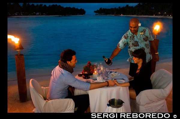 Aitutaki. Cook Island. Polynesia. South Pacific Ocean. A couple enjoys a romantic dinner by the beach in Aitutaki Lagoon Resort & Spa Hotel. As the only resort directly on the world's most beautiful lagoon, The Aitutaki Lagoon Resort & Spa is truly blessed. This exclusive all-bungalow resort is one-of-a-kind in many other respects also. It is the only private island resort in the Cook Islands. The Aitutaki Lagoon Resort & Spa is a luxury resort destination on one of the most famous lagoons in the world. This Cook Islands paradise provides a naturally romantic setting, and the resort is a popular accommodation option, especially with honeymoon couples, those wishing to get married in Aitutaki, and anyone looking for an idyllic paradise island getaway. Guests may choose between beachfront and garden bungalows or opt for an overwater bungalow - the only destination in Cook Islands to offer overwater accommodation. The resort offers top hotel amenities, fine cuisine and a range of recreational activities: 7 Overwater bungalows - Cook Islands only overwater accommodation. 14 Beachfront and 16 Garden bungalows. Air-conditioning, TV/DVD/CD, king or queen beds, mini-bar etc. Relax at The Flying Boat Beach Bar & Grill. The Bounty Restaurant offers fine dining experience. Theme nights and Aitutaki entertainment. Complimentary activities include snorkeling, kayaking, biking, beach volleyball, guided hikes and cultural activities. Pay-for activities include deep sea fishing and scuba diving. Romantic wedding packages. Spa Facility at the SpaPolynesia, with extensive health and beauty treatments available. Complimentary bottle of champagne and his/hers island pareus (sarongs) for honeymooners staying for 3 nights or more. Aitutaki is about 40 minutes by air from the International Airport on Rarotonga. The resort is located on Akitua island, with wonderful views over this breathtakingly beautiful lagoon.