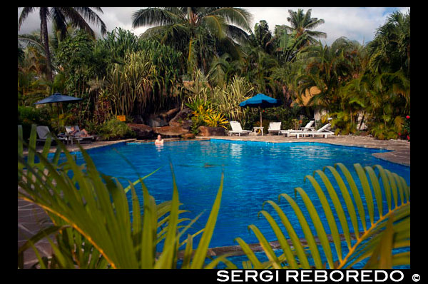 Rarotonga Island. Cook Island. Polynesia. South Pacific Ocean. Swimming pool of the Crown Beach Resort & Spa Hotel. The Resort is a full service yet intimate luxury boutique resort with 36 individual villas, located amongst 4.5 acres of tropical gardens. Situated at Aroa beach on Raratonga, the Crown Beach Resort has a luxury spa for those in need of relaxation and some pampering. For the active guest there is a gym, and activities such as the cultural tour, an off-road tour and whale spotting excursions. Nestled amongst acres of tropical gardens and bordered by the white sand beaches and a crystal blue lagoon, lies the 36 Crown Beach villas, all set with the utmost care and attention to detail in each room.  The utmost care has gone into the design and decor of these luxurious rooms creating an absolute haven for you and your loved one, choose between your own private swimming pool or Jacuzzi for intimate moments in complete privacy. The resort offers an onsite spa and beauty clinic to enhance your relaxing stay, be pampered by the wonderful treatments and talented staff. Enjoy an evening of culinary delights at any of the resorts three onsite dining venues, Windjammer Restaurant offers intimate, fine dining, Tan Tapas Lounge presents an exotic atmosphere with and serving Spanish Tapas.  For entertainment with your meal, visit the Oceans Brasserie dishing up a superior buffet fare with the ultimate cultural show to amuse and entrance you in a relaxed and vibrant atmosphere. For the true meaning of retreat, luxury and romance, visit the Crown Beach Resort & Spa to experience the most exotic and indulgent of sun soaked holidays in this paradise of the Pacific.